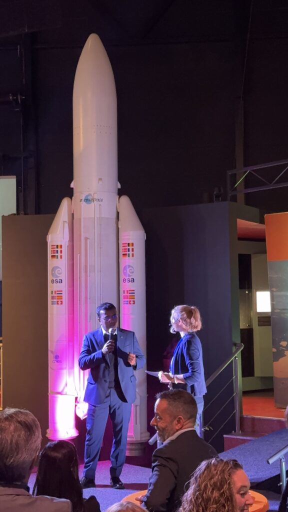 space business professionals on stage amid space exhibits