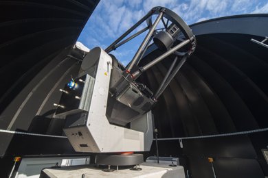 ground station telescope with blue sky overhead