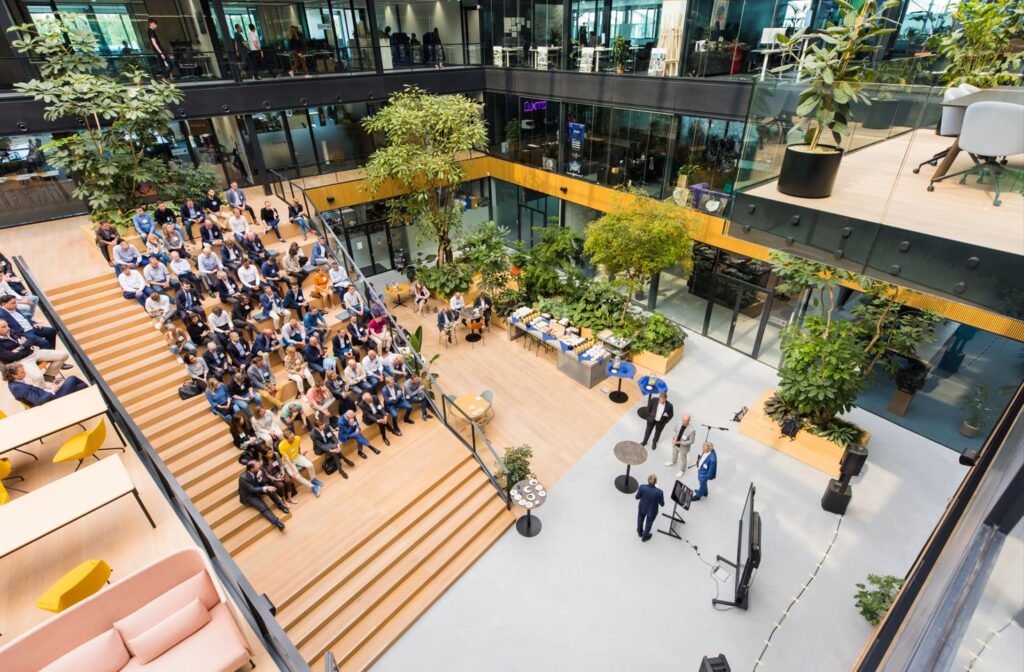 agenda launch in atrium with guests on tiered seating