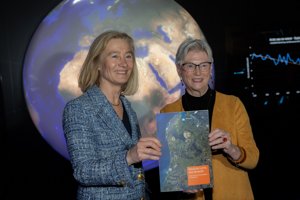 two female government ministers holding the new long-term space agenda publication