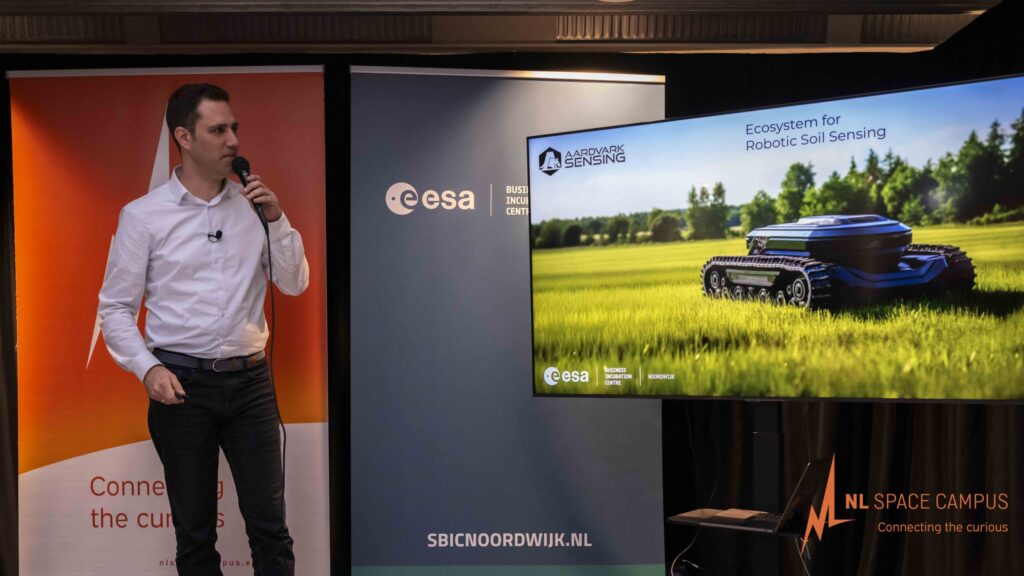 ESA BIC entrepreneur presenting to the space business community in the atrium at SBIC Noordwijk